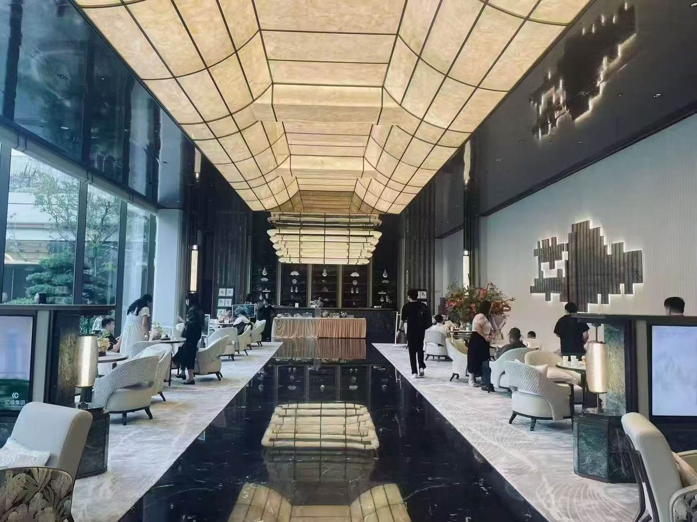 Backlit translucent faux alabaster panels in a hotel lobby corridor by ETERNAL