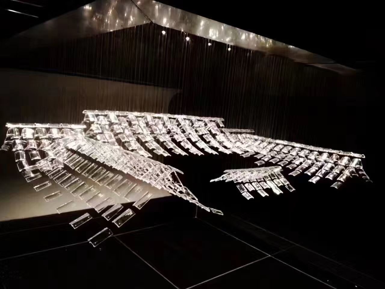 Suspended crystal glass tile installation glowing at night