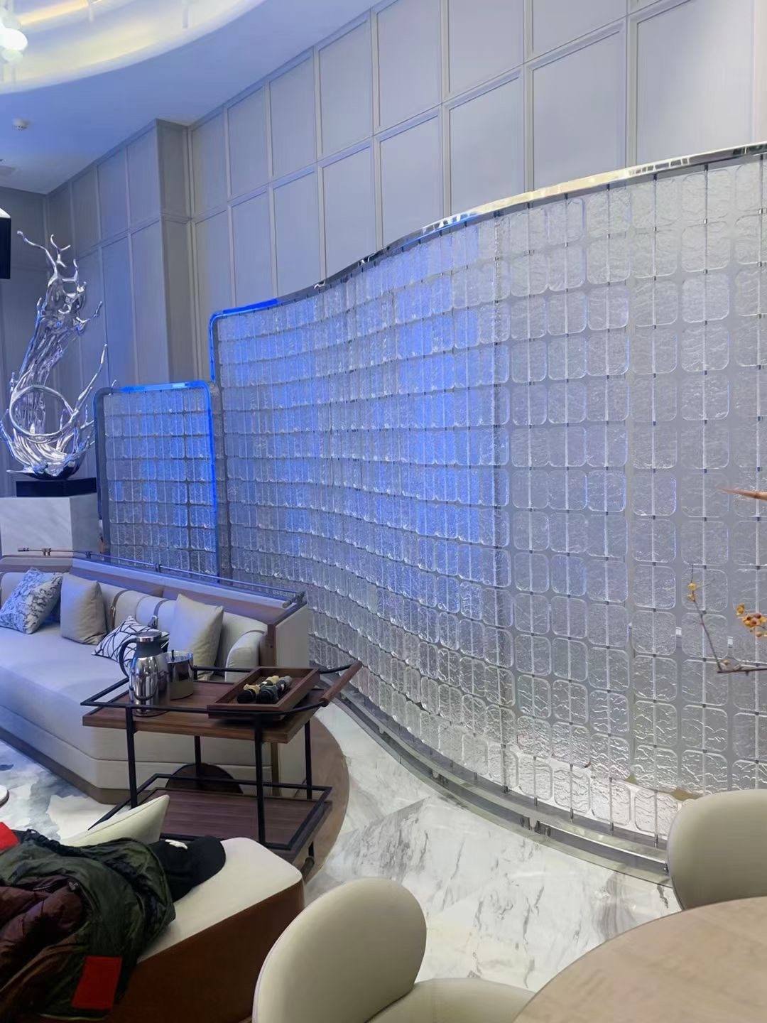Curved crystal glass tile art wall in a clubhouse lounge by ETERNAL