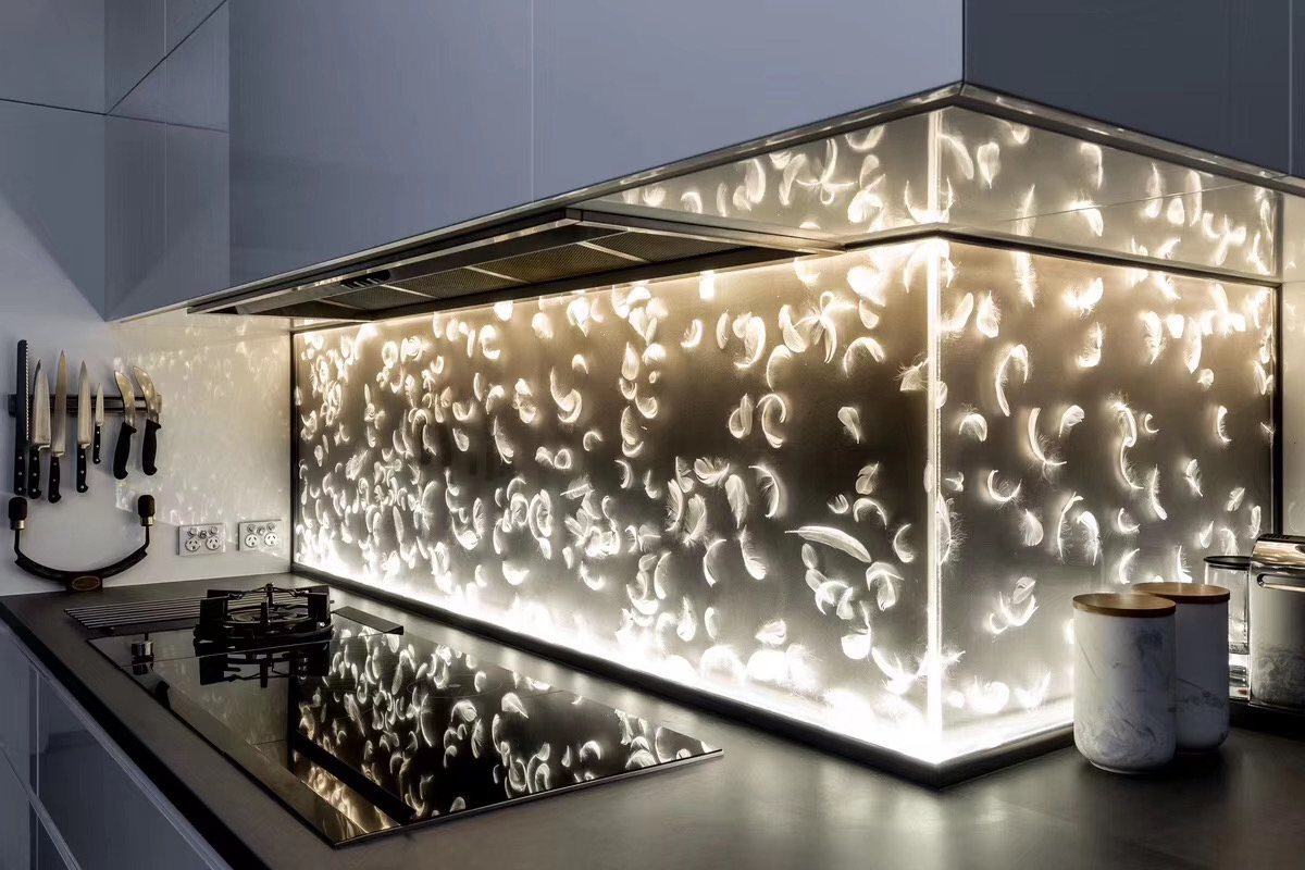 Feather pattern backlit glass feature wall in a brand showroom by ETERNAL