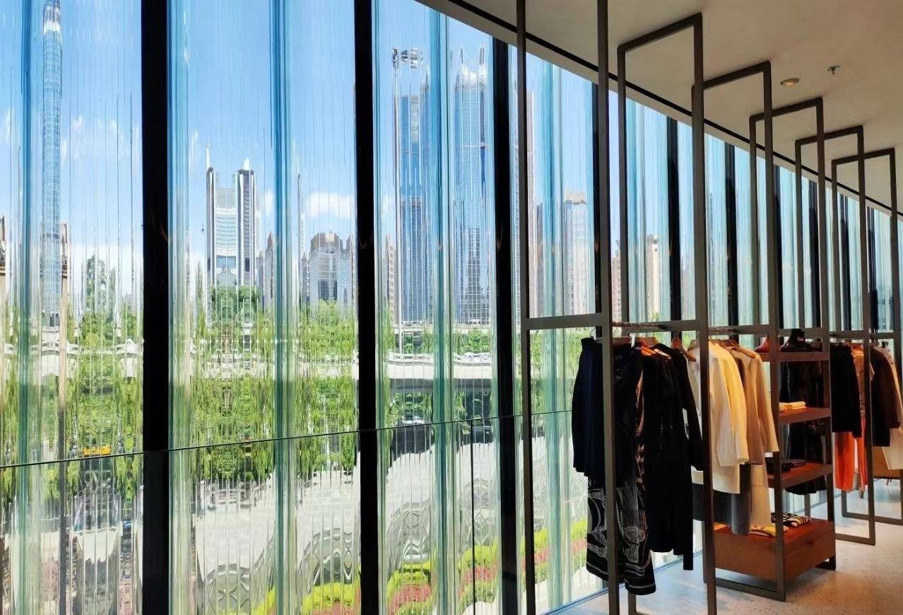 Interior curved fluted glass curtain wall of a luxury brand boutique by ETERNAL