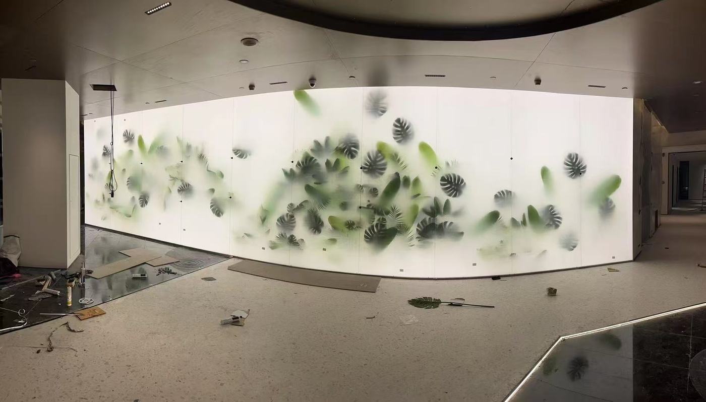 Curved botanical plant-pattern glass feature wall panorama in a hotel lobby by ETERNAL